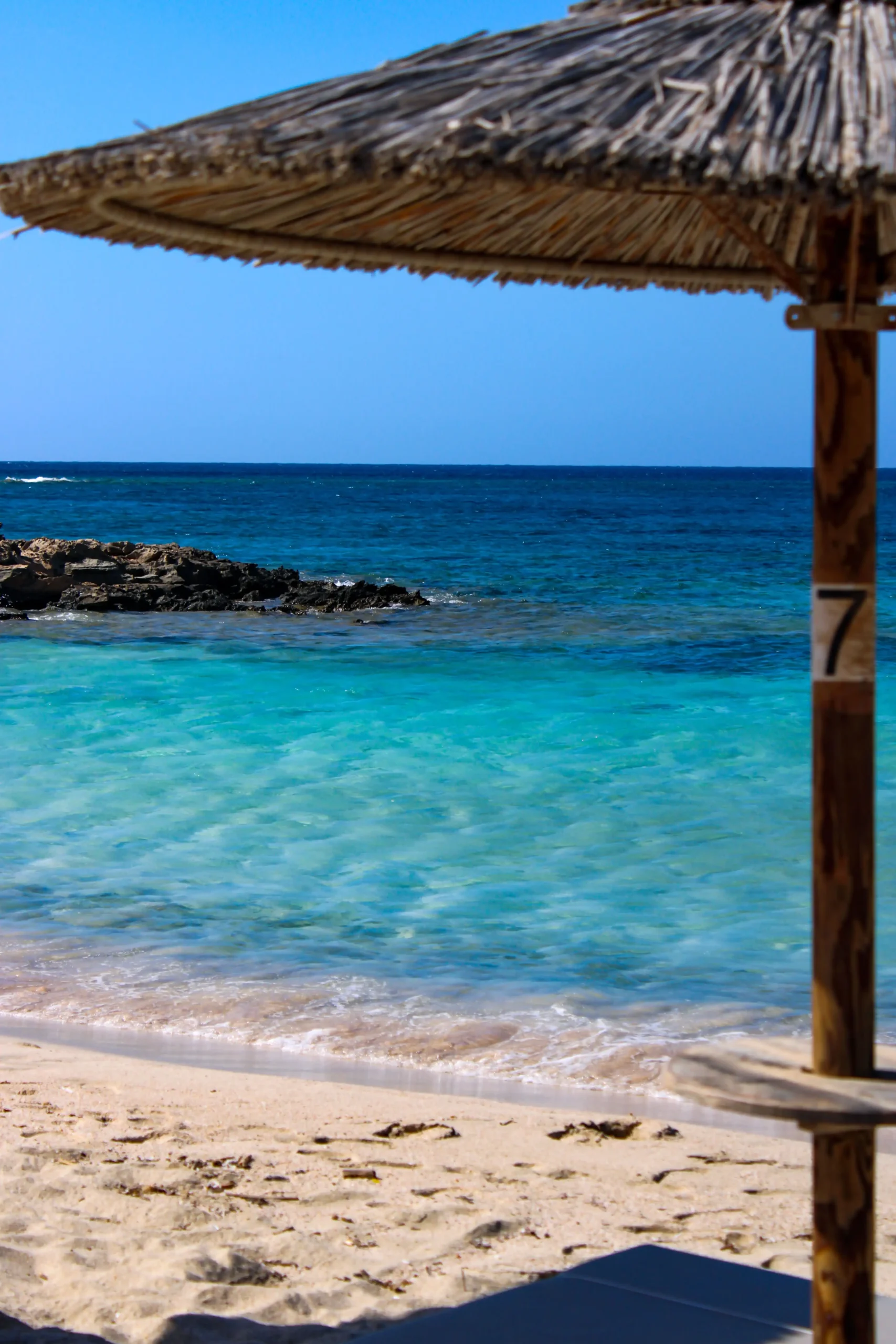 pexels photo 33259944 33259944 scaled Elafonissi beach in Crete with turquoise water, pale sand and a thatched sun umbrella